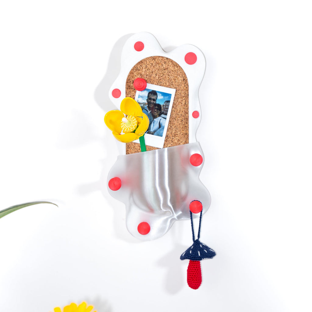 Decorative cork board with colorful pins and a photo on a white background