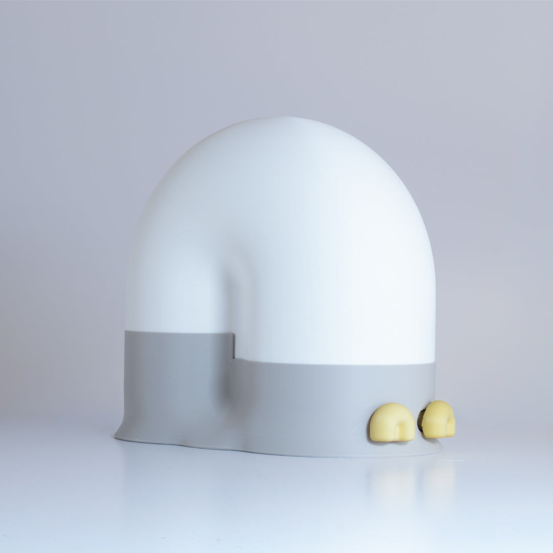 White snail-shaped lamp with a gray base and yellow eyes on a light gray background