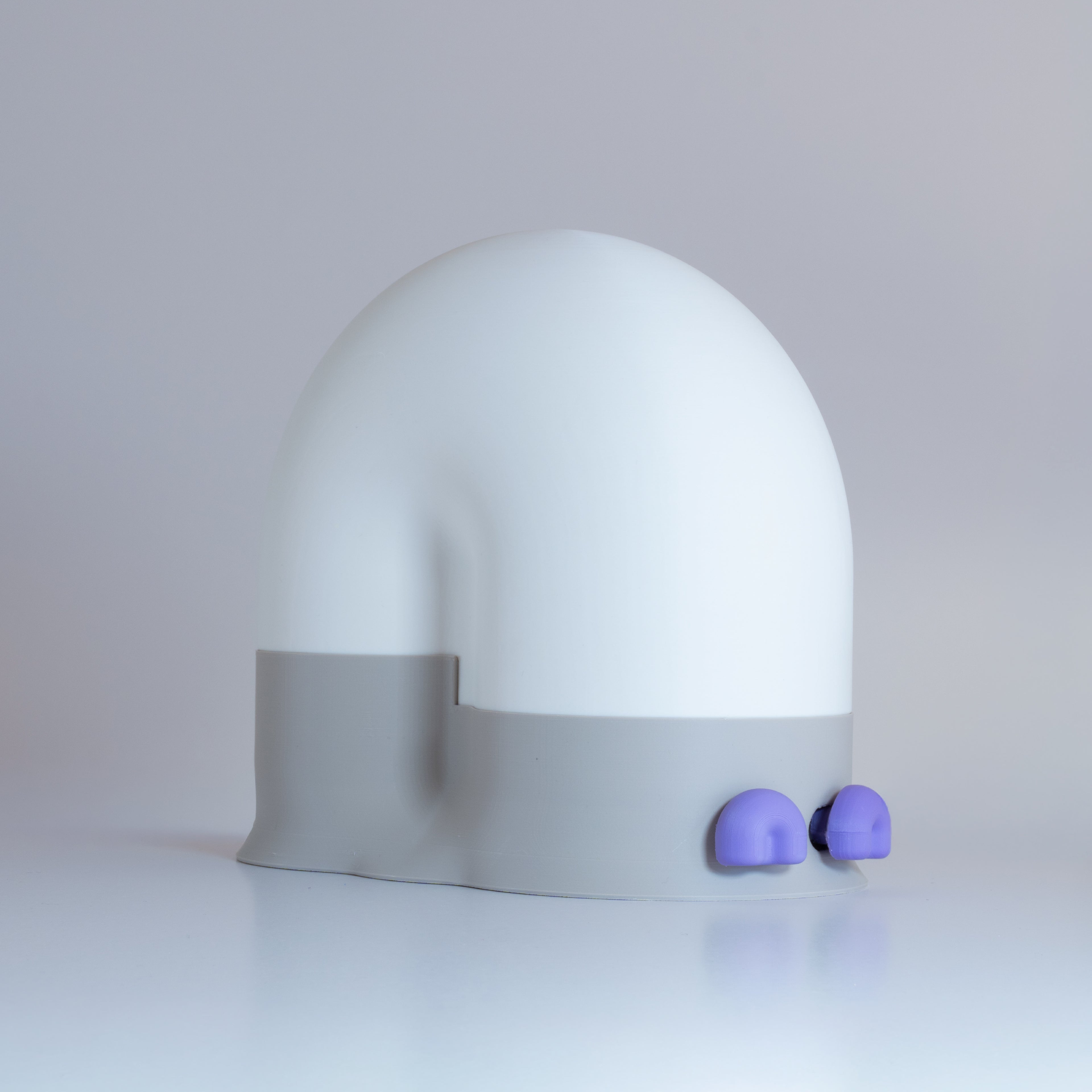 White snail-shaped lamp with a gray base and lavender eyes on a light gray background