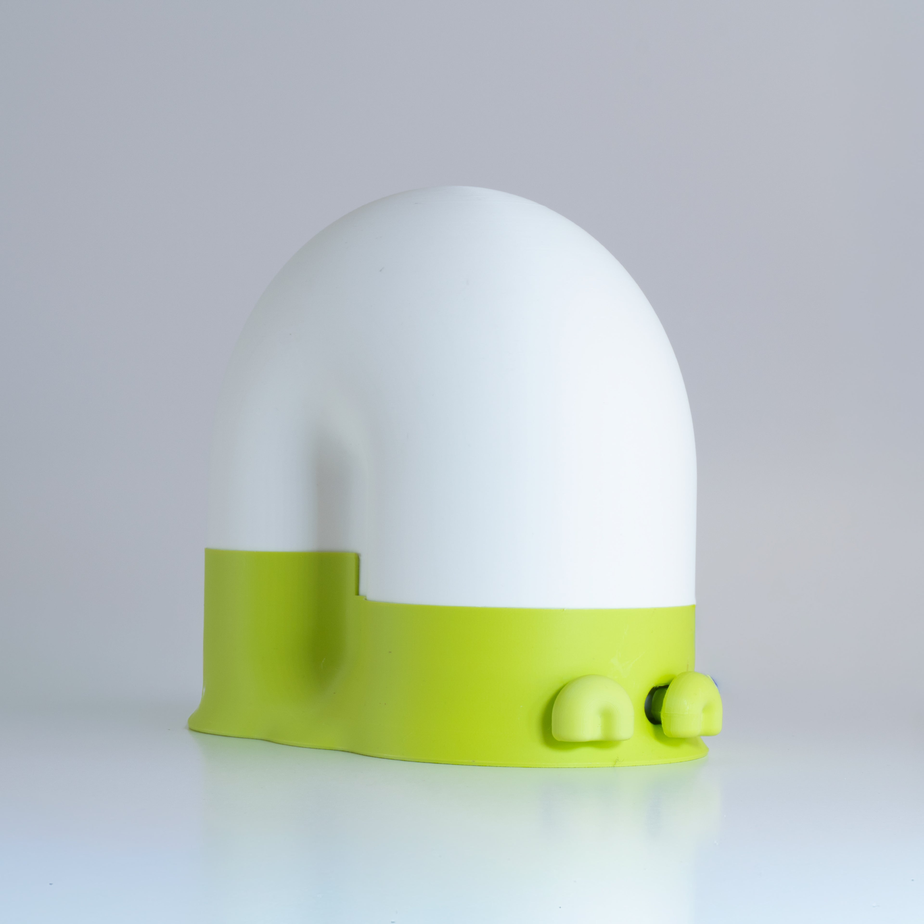 White snail-shaped lamp with a lime green base and lime green eyes on a light gray background