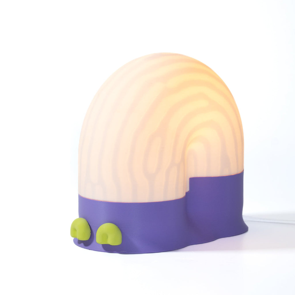 Round lamp with purple base and green accents on a white background