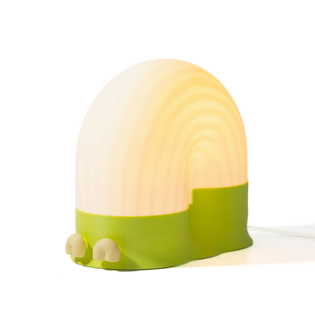 Snail-shaped night light with a green base and white shell on a white background