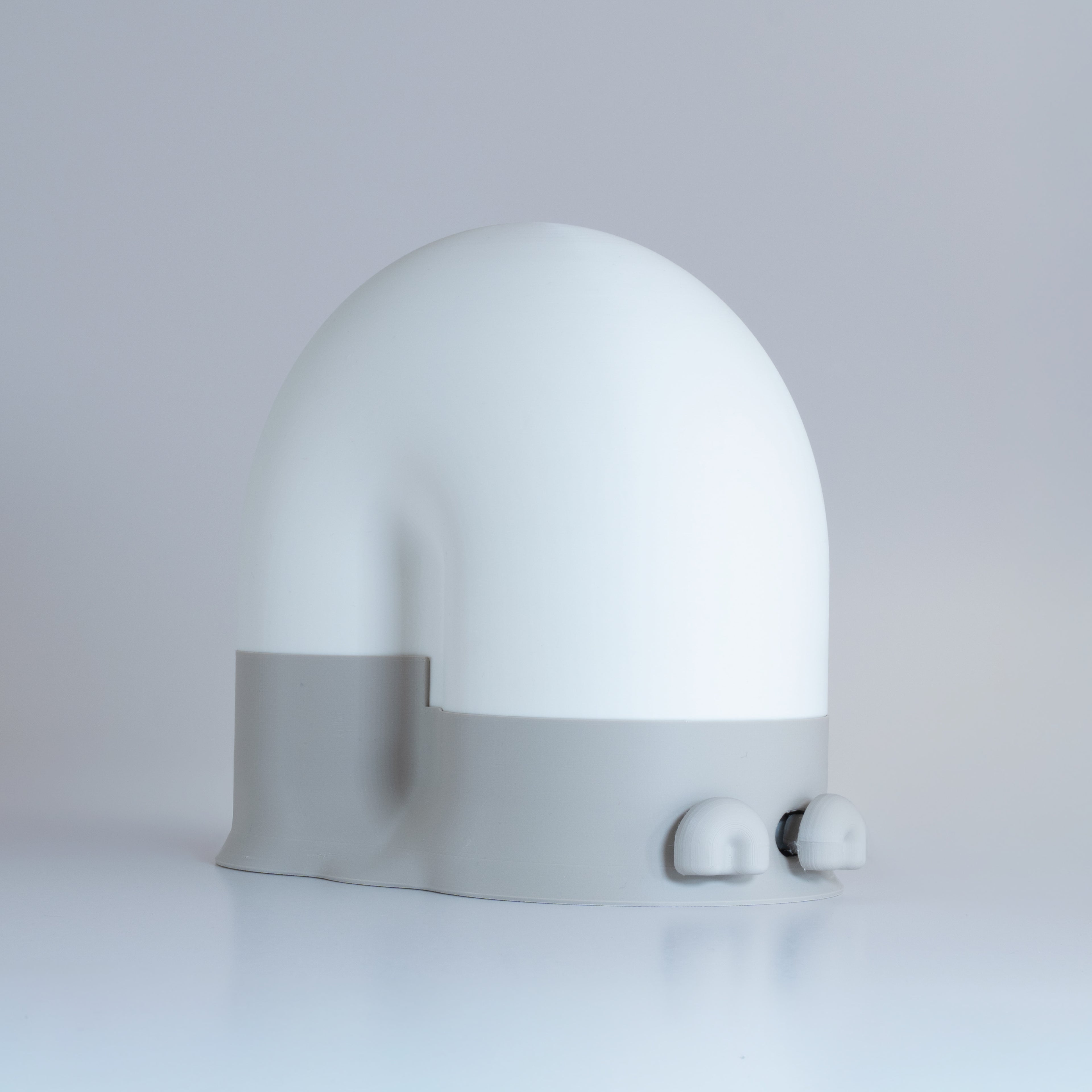 White snail-shaped lamp with a gray base and gray eyes on a light gray background