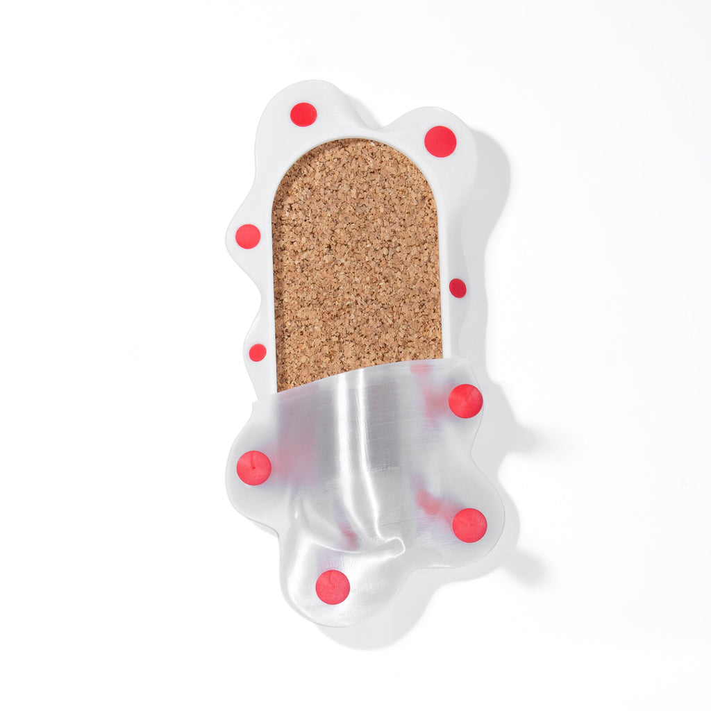 Decorative cork  panel with red polka dots on a white background