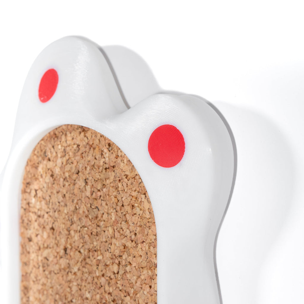 White wall organizer with cork background and red spots on a white background