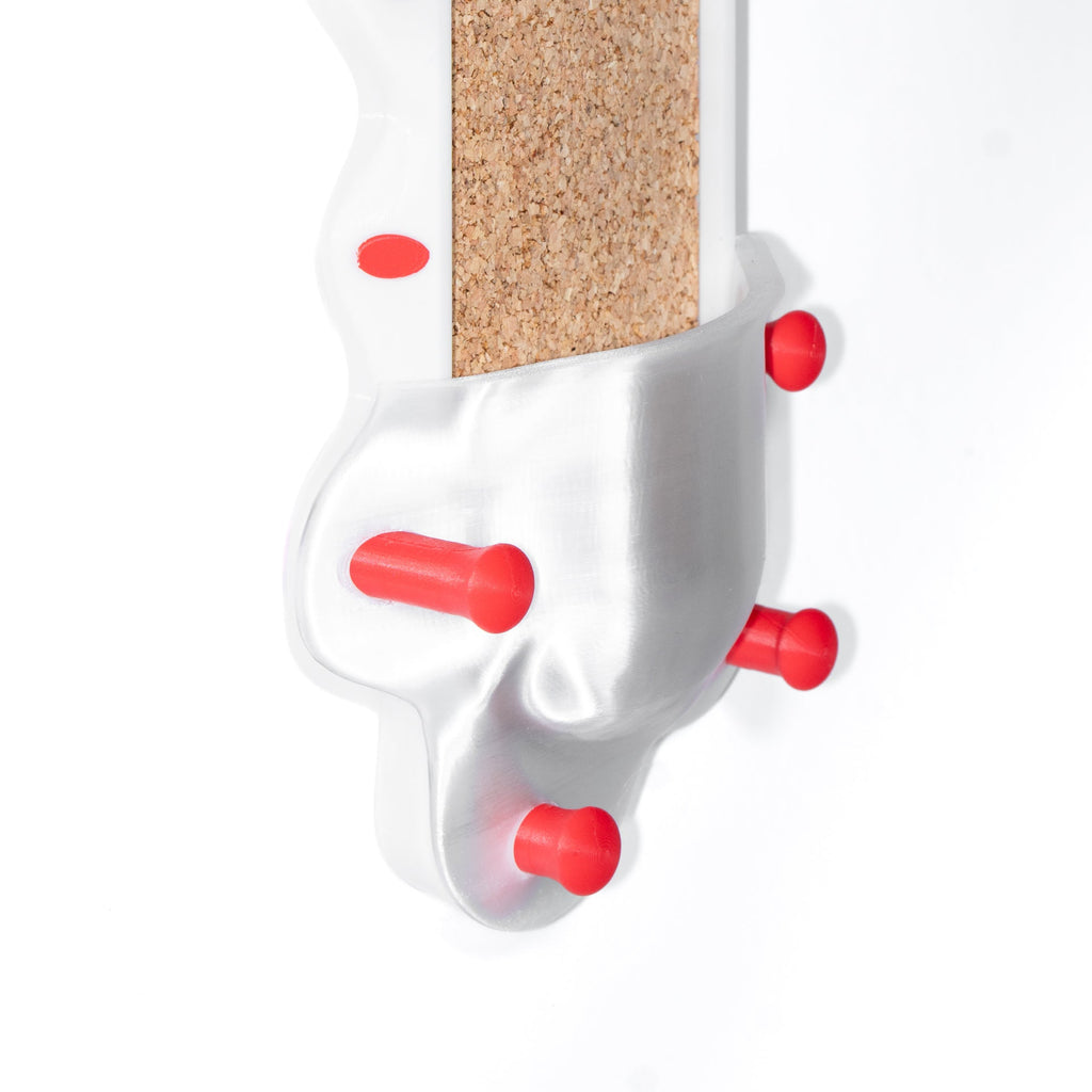 Whitewall organizer with a cork block and red accents on a white background